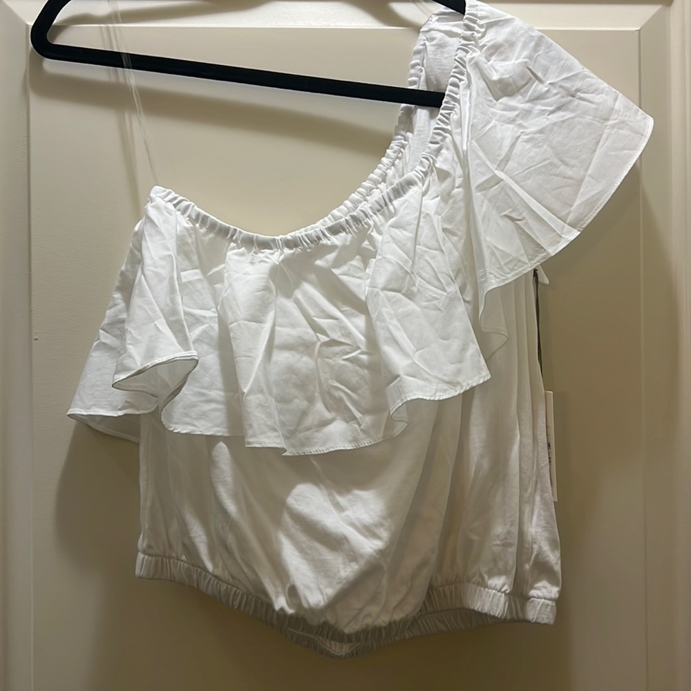 A New Day white one shoulder top. All white with one level of ruffles all around